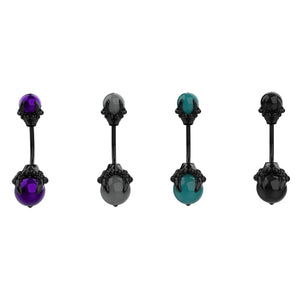 Four belly button rings with black skull designs and colored gemstones