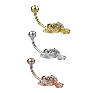 Three gold, silver, and rose gold belly rings with clear gemstones 