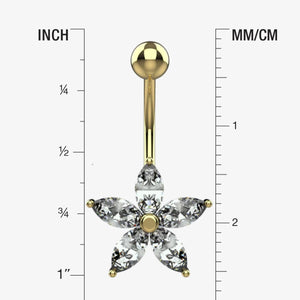 Gold belly button ring with clear gemstones on a measurement chart